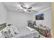 Bedroom with a bed, ceiling fan, and a wall-mounted TV, perfect for relaxation at 3819 Shane Ct, Ellenwood, GA 30294
