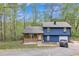 Charming two-story home with a manicured lawn, attached garage, and a rustic porch with wood paneling at 3819 Shane Ct, Ellenwood, GA 30294