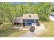 Two-story home with blue siding, a garage, covered porch and landscaped yard and an expansive driveway at 3819 Shane Ct, Ellenwood, GA 30294