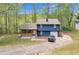 Two-story home with blue siding, a garage, covered porch and landscaped yard and an expansive driveway at 3819 Shane Ct, Ellenwood, GA 30294