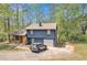 Two-story home with blue siding, a garage, covered porch and landscaped yard and an expansive driveway at 3819 Shane Ct, Ellenwood, GA 30294