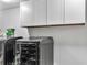 A sleek laundry room with modern appliances and stylish white cabinetry above at 3819 Shane Ct, Ellenwood, GA 30294