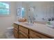 Bright bathroom featuring a wood vanity with countertop and a window bringing in natural light at 435 Chantenay Pl, Alpharetta, GA 30022