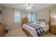 Comfortable bedroom featuring a bed, dresser, and natural light from the windows at 435 Chantenay Pl, Alpharetta, GA 30022