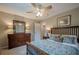 Comfortable bedroom featuring a bed, dresser, and ceiling fan at 435 Chantenay Pl, Alpharetta, GA 30022