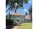 Charming two-story home featuring a well-manicured lawn, gray siding, and classic architectural details at 435 Chantenay Pl, Alpharetta, GA 30022