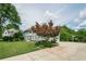 Attractive home with mature trees, lush landscaping, and a long driveway leading to a garage at 435 Chantenay Pl, Alpharetta, GA 30022