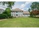 Beautifully landscaped front yard and two-story home featuring a large lawn and neutral color scheme at 435 Chantenay Pl, Alpharetta, GA 30022