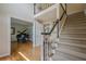 Foyer with hardwood floors, stairs with carpet runner, and views of the piano room at 435 Chantenay Pl, Alpharetta, GA 30022