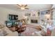 Inviting living room featuring a fireplace, a ceiling fan, and a mounted television for entertainment at 435 Chantenay Pl, Alpharetta, GA 30022