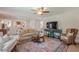 Spacious living room with a patterned rug, comfortable seating, and an open view to the adjacent kitchen at 435 Chantenay Pl, Alpharetta, GA 30022