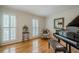 Cozy living room with a grand piano, shutters, and comfortable seating at 435 Chantenay Pl, Alpharetta, GA 30022