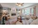 Comfortable living room with a white-painted brick fireplace, built-in shelves, and a large bay window at 435 Chantenay Pl, Alpharetta, GA 30022