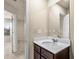 Bathroom featuring a vanity with a dark wood finish, a white countertop, and a large mirror at 10786 Wheeler Trce, Hampton, GA 30228