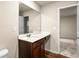 Bathroom with a vanity, large mirror, and wood floors at 10786 Wheeler Trce, Hampton, GA 30228
