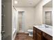 Bathroom featuring a tub with shower and dark wood cabinets with white sink at 10786 Wheeler Trce, Hampton, GA 30228