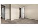 Vacant bedroom with neutral carpet and walls features a door to a closet and a door leading to another room at 10786 Wheeler Trce, Hampton, GA 30228