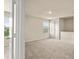Bright, carpeted bedroom with a view to the exterior at 10786 Wheeler Trce, Hampton, GA 30228