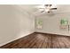 Bedroom with hardwood floors, two windows, and neutral walls at 10786 Wheeler Trce, Hampton, GA 30228