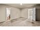 Bedroom featuring neutral carpet and an attached bathroom at 10786 Wheeler Trce, Hampton, GA 30228