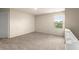 Carpeted bonus room features white walls, a window, and access to a staircase at 10786 Wheeler Trce, Hampton, GA 30228