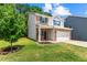 Attractive home with a tidy front yard and a combination of brick and gray siding at 10786 Wheeler Trce, Hampton, GA 30228