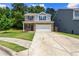Well-maintained home with a spacious driveway and a manicured lawn in a residential neighborhood at 10786 Wheeler Trce, Hampton, GA 30228