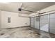 Clean garage featuring a garage door, overhead lighting, and ample storage at 10786 Wheeler Trce, Hampton, GA 30228