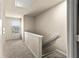 Bright hallway area with a window and neutral carpeting and paint at 10786 Wheeler Trce, Hampton, GA 30228