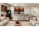 Modern kitchen featuring wooden cabinets, granite counters, and an island with seating at 10786 Wheeler Trce, Hampton, GA 30228
