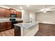 Open-concept kitchen boasting a granite island and ample counter space at 10786 Wheeler Trce, Hampton, GA 30228