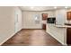 A kitchen with hardwood floors, granite counters, and dark wood cabinets at 10786 Wheeler Trce, Hampton, GA 30228