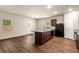 Bright open-concept with a kitchen featuring an island with a sink and breakfast bar seating at 10786 Wheeler Trce, Hampton, GA 30228