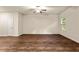 Spacious living room boasting hardwood floors, ample natural light, and a ceiling fan at 10786 Wheeler Trce, Hampton, GA 30228