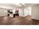Open-concept living room features a kitchen, wood floors, and natural light at 10786 Wheeler Trce, Hampton, GA 30228
