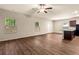 Spacious open-concept living area with hardwood floors and plenty of natural light at 10786 Wheeler Trce, Hampton, GA 30228