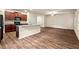 Open-concept living area featuring a combined kitchen and living space with modern finishes at 10786 Wheeler Trce, Hampton, GA 30228
