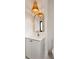 Elegant bathroom with a stylish vanity, gold accents, and a modern woven light fixture at 11536 Serenbe Ln, Chattahoochee Hills, GA 30268