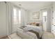 Neutral bedroom with large windows, hardwood floors, and plush bedding at 11536 Serenbe Ln, Chattahoochee Hills, GA 30268