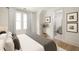 Serene bedroom with hardwood floors, neutral tones, and ensuite bathroom access at 11536 Serenbe Ln, Chattahoochee Hills, GA 30268
