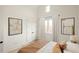 Bright bedroom with light wood floors, neutral decor and ensuite at 11536 Serenbe Ln, Chattahoochee Hills, GA 30268