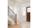 Light and airy entryway with hardwood floors, stairs, and a craftsman-style front door at 11536 Serenbe Ln, Chattahoochee Hills, GA 30268