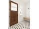 Bright entryway featuring a stylish black and white tiled floor and a wooden bench at 11536 Serenbe Ln, Chattahoochee Hills, GA 30268