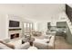 Open-concept living room with fireplace, dining area, and modern kitchen; perfect for entertaining at 11536 Serenbe Ln, Chattahoochee Hills, GA 30268