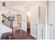 Hallway view with hardwood floors and staircase in view, leading to an open living area at 196 Boulder Run, Hiram, GA 30141