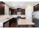 Well-equipped kitchen features stainless appliances, granite countertops, and dark wood cabinetry at 196 Boulder Run, Hiram, GA 30141