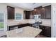 Modern kitchen with dark cabinets, stainless steel appliances, and a center island with granite countertops at 196 Boulder Run, Hiram, GA 30141