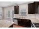 Spacious kitchen with dark wood cabinetry, granite countertops, and stainless steel appliances at 196 Boulder Run, Hiram, GA 30141