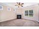 Inviting living room features plush carpet, a fireplace, and large windows for natural light at 196 Boulder Run, Hiram, GA 30141