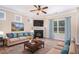 Cozy living room features a fireplace, plush carpet, and large windows for natural light at 196 Boulder Run, Hiram, GA 30141